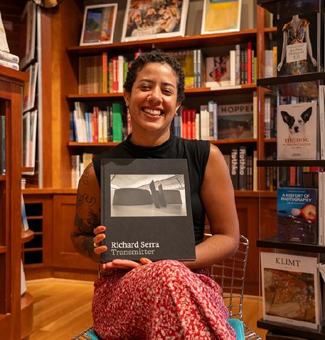 Amanda holding up a book in the shop